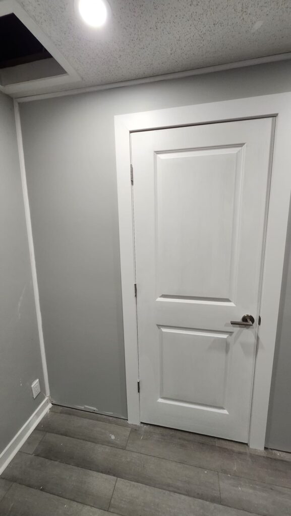 New white interior door with painted walls and new flooring