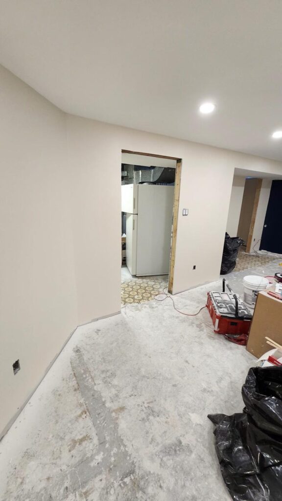 Basement hallway with smooth finished walls ready for flooring