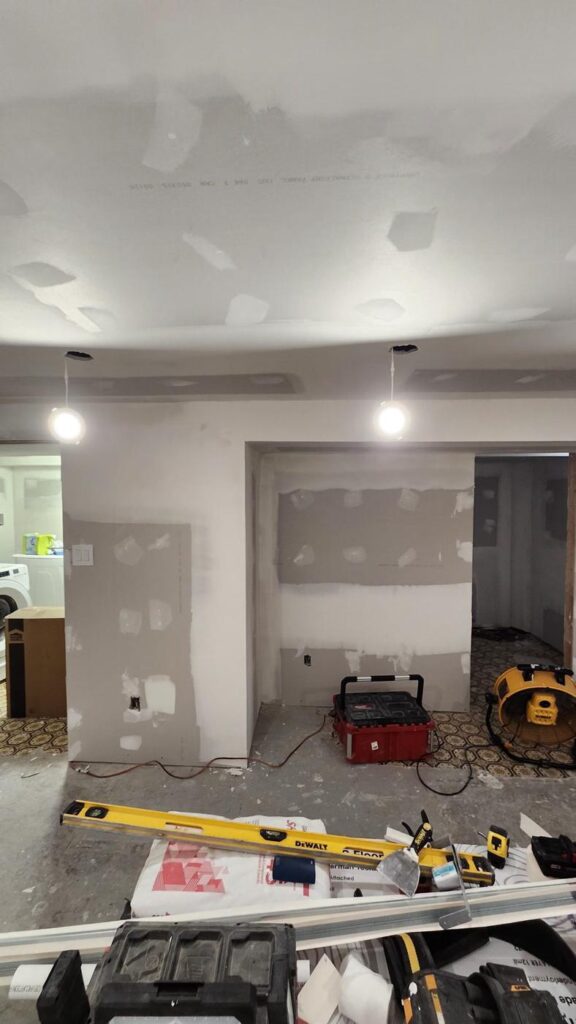 Drywall seams taped and mudded in a basement room