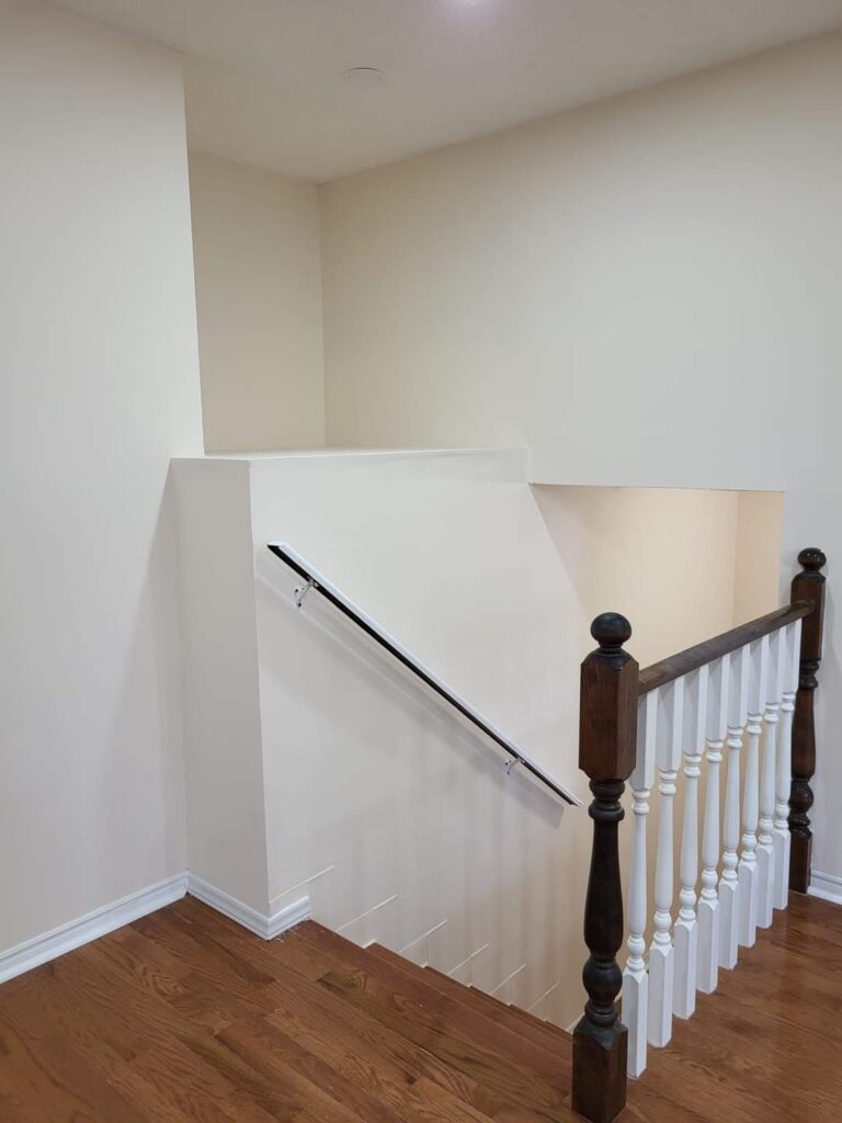 Finished and painted stairwell with new handrail and drywall