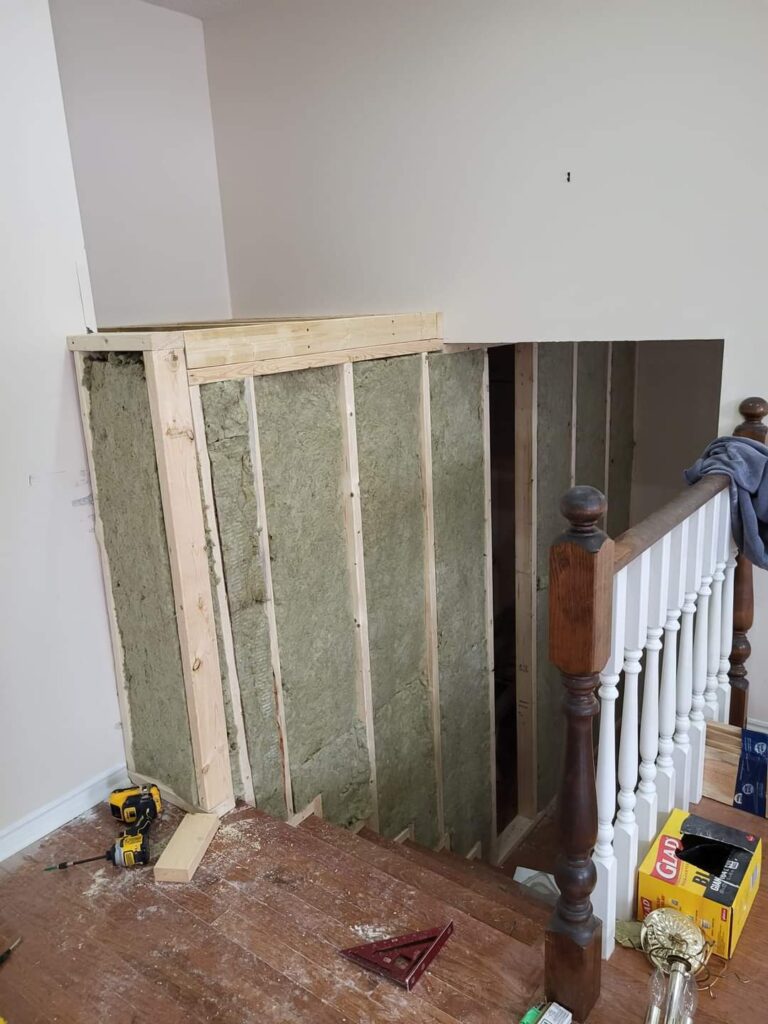 Stairwell wall framed and insulated before drywall